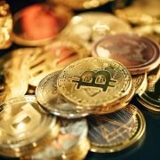 a pile of gold and silver coins sitting on top of a table