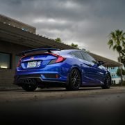 a blue car parked outside a building