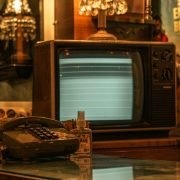 an old fashioned telephone sitting on top of a glass table