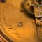 a close up of a gold pocket watch