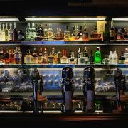 bottles on brown wooden shelf