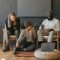 Three coworkers sitting together laughing Surface laptop on furniture