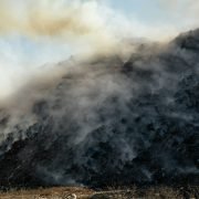 smoke billowing out of the top of a mountain