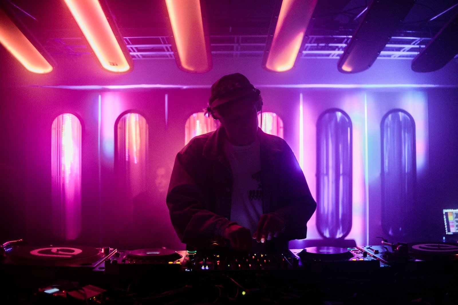 A dj mixing music in a dark room