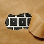 A piece of cardboard with a keyboard appearing through it