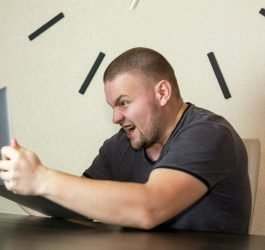 a man sitting in front of a laptop computer