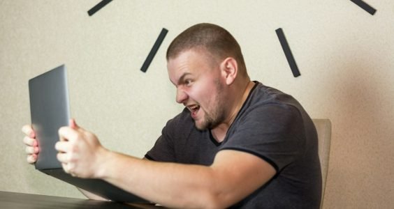 a man sitting in front of a laptop computer